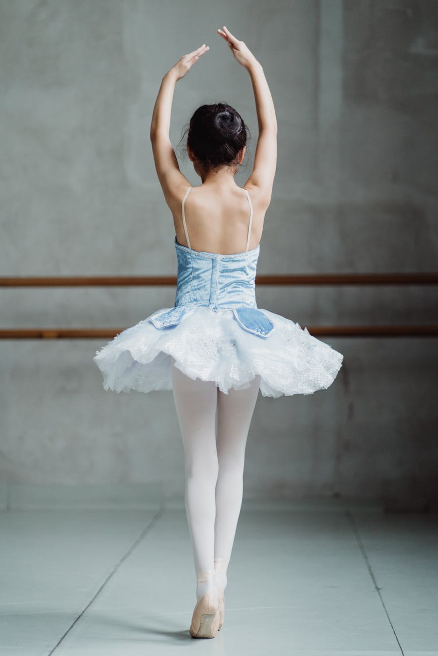 Ballet dancer on tiptoes with hands up. CurioBuddy promotes all form of creativity. Join #CreateWithCB today.